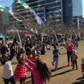 kids playing with bubbles in park